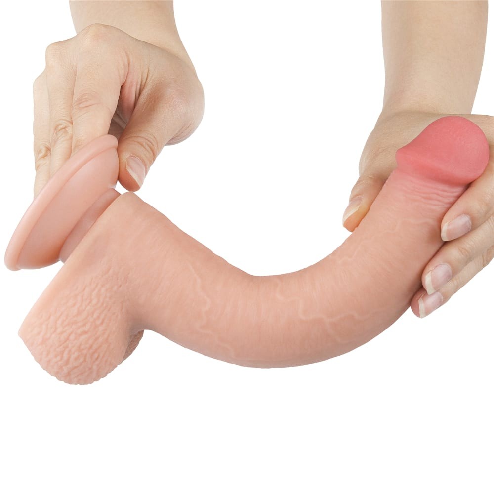 Dildo-ul Lovetoy Sliding Skin 9 inch curbat, cu pielea culisanta trasa simultan, demonstrand flexibilitatea totala