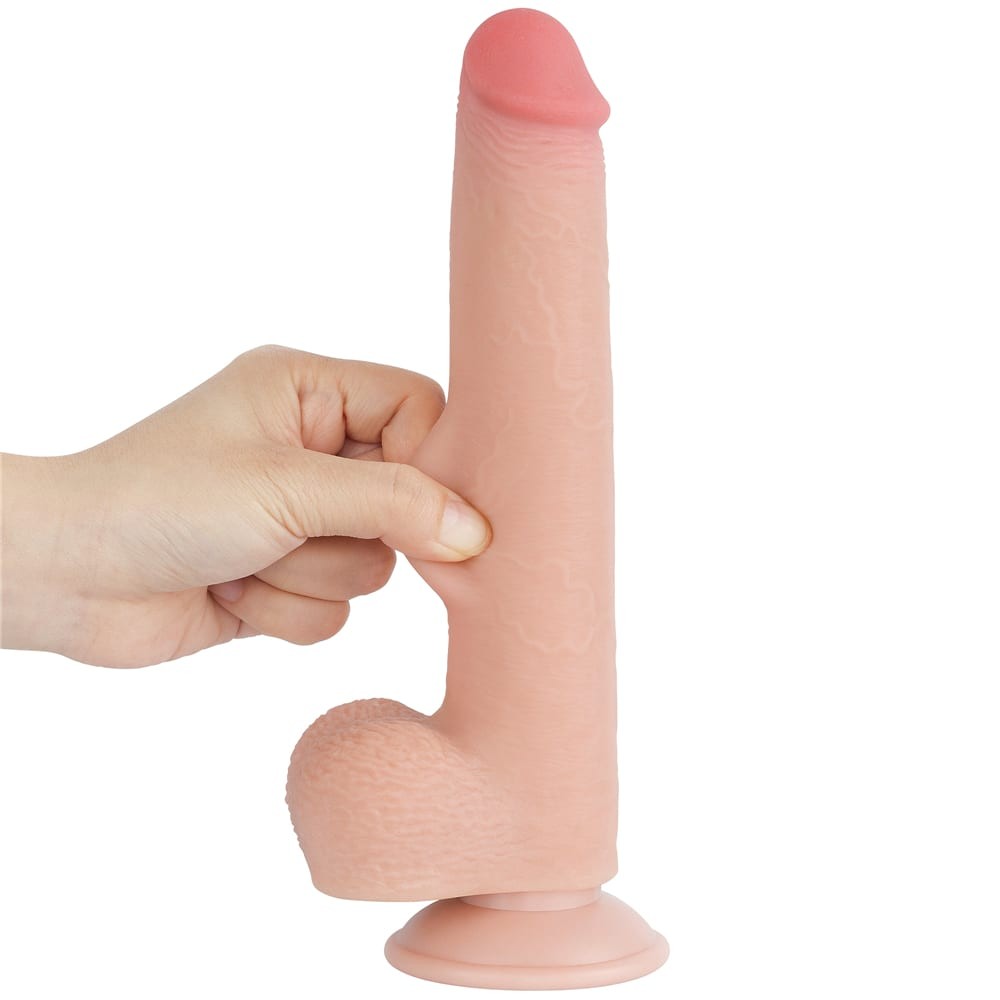 Deget apasat in tija dildo-ului Lovetoy Sliding Skin 9 inch, aratand moliciunea stratului exterior