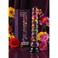 Dildo cu bile Everlasting Bloom by ToyJoy, multicolor, vedere de ansamblu pe fundal cu flori