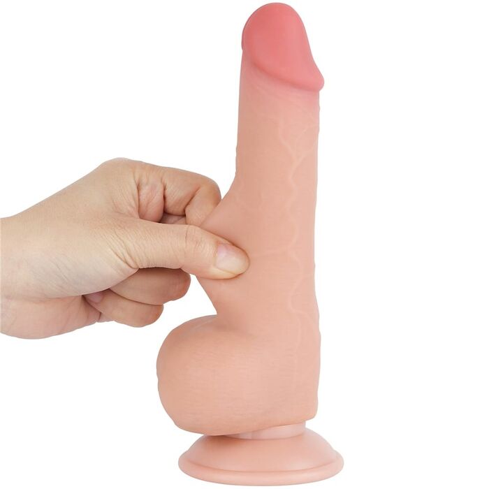 Deget apasat in tija dildo-ului Lovetoy Sliding Skin, aratand moliciunea stratului exterior