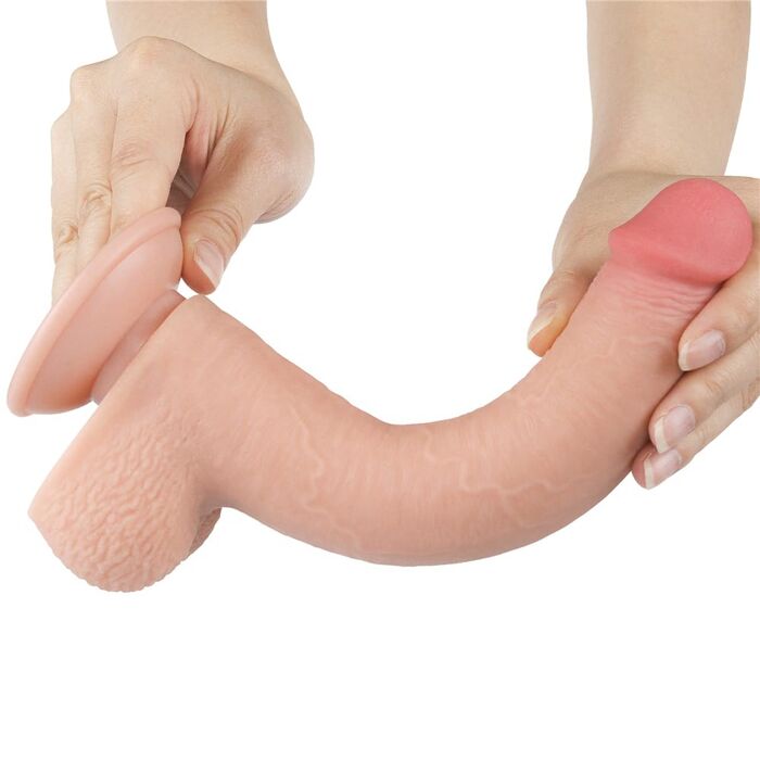 Dildo-ul Lovetoy Sliding Skin 9 inch curbat, cu pielea culisanta trasa simultan, demonstrand flexibilitatea totala