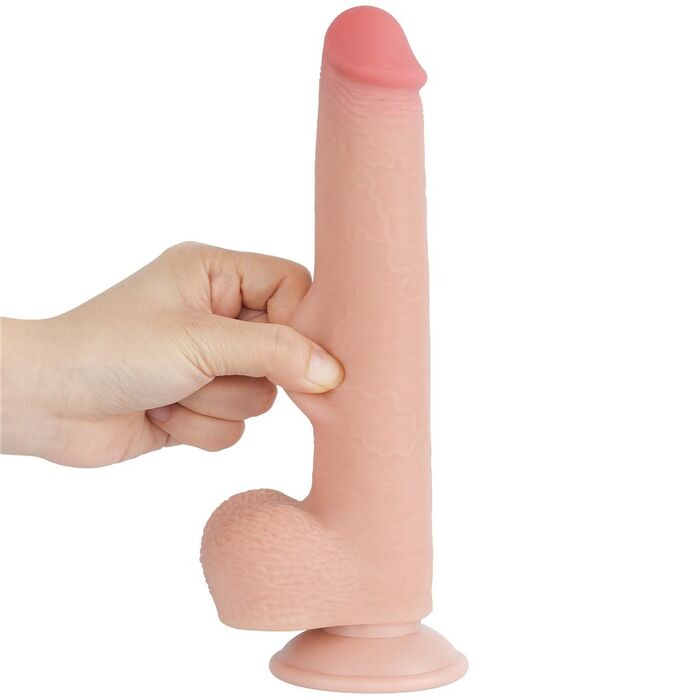 Deget apasat in tija dildo-ului Lovetoy Sliding Skin 9 inch, aratand moliciunea stratului exterior